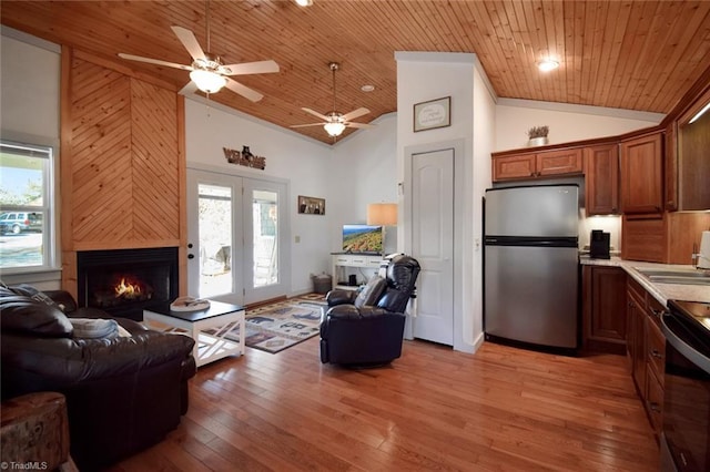 living room with a fireplace, high vaulted ceiling, light hardwood / wood-style flooring, and wooden ceiling