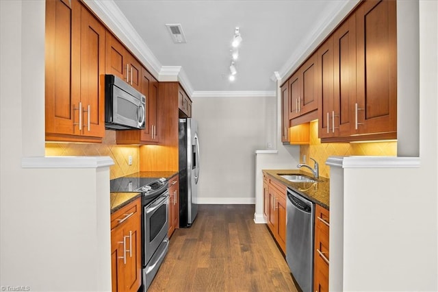 6832 Main St Unit 226, Wilmington, NC 28405 - kitchen featuring appliances with stainless steel finishes, dark wood-type flooring, backsplash, brown cabinets, and ornamental molding