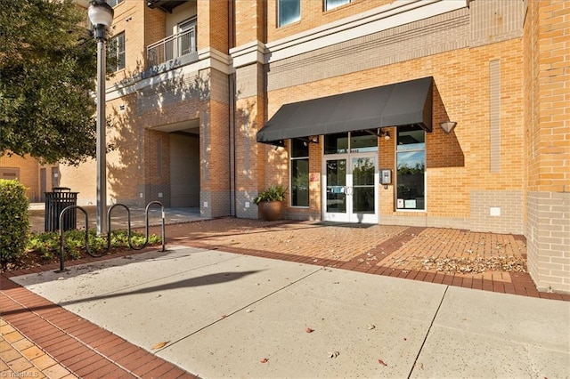 6832 Main St Unit 226, Wilmington, NC 28405 - doorway to property featuring brick siding and french doors