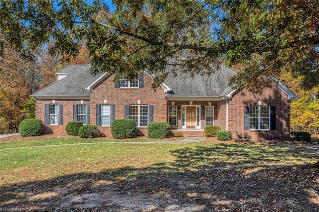 8105 Summit Springs Ct, Browns Summit, NC 27214 - traditional home featuring brick siding, a front lawn, and roof with shingles