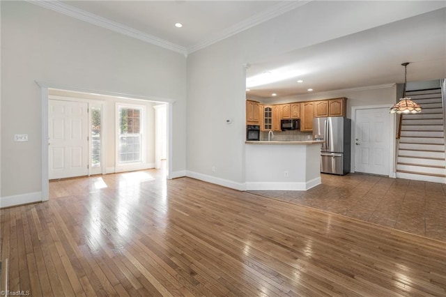 8105 Summit Springs Ct, Browns Summit, NC 27214 - unfurnished living room with hardwood / wood-style flooring, stairway, crown molding, baseboards, and recessed lighting