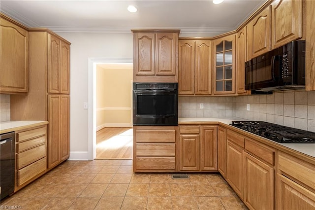 8105 Summit Springs Ct, Browns Summit, NC 27214 - kitchen with black appliances, glass insert cabinets, tasteful backsplash, ornamental molding, and recessed lighting