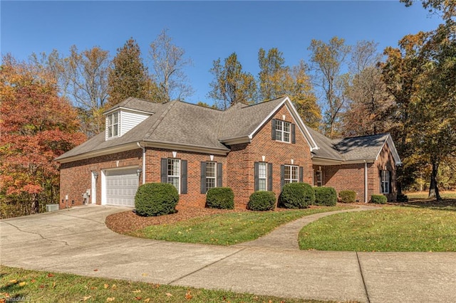 8105 Summit Springs Ct, Browns Summit, NC 27214 - view of front of home featuring brick siding, a front lawn, concrete driveway, and an attached garage
