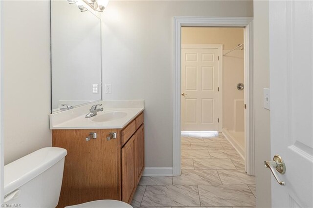 8105 Summit Springs Ct, Browns Summit, NC 27214 - bathroom with marble finish flooring, toilet, vanity, and baseboards