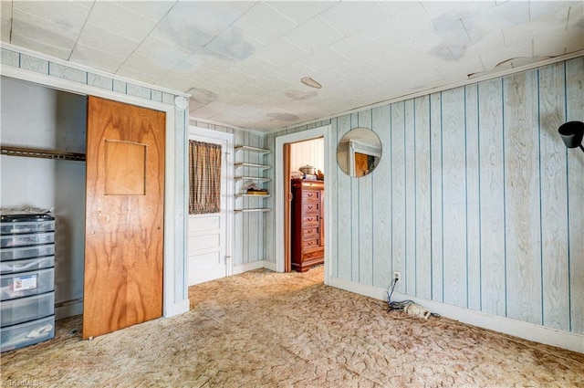 2405 Ellington St, Greensboro, NC 27403 - empty room with carpet floors and wood walls