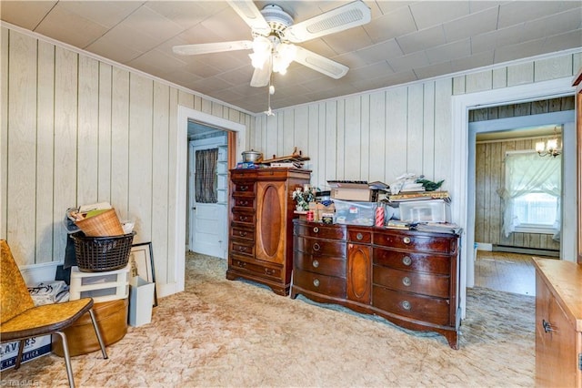 2405 Ellington St, Greensboro, NC 27403 - bedroom featuring a baseboard radiator, wood walls, and a chandelier