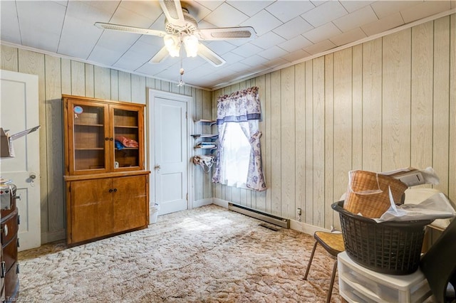 2405 Ellington St, Greensboro, NC 27403 - carpeted dining space with ceiling fan, wooden walls, and a baseboard heating unit