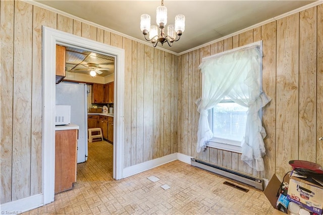 2405 Ellington St, Greensboro, NC 27403 - unfurnished dining area featuring a baseboard heating unit, wooden walls, a chandelier, brick patterned flooring, and crown molding