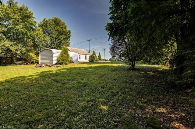 2405 Ellington St, Greensboro, NC 27403 - view of green lawn with a storage unit