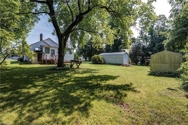 2405 Ellington St, Greensboro, NC 27403 - view of grassy yard with a storage unit