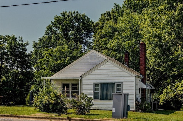 2405 Ellington St, Greensboro, NC 27403 - view of front of house with a front yard and a chimney