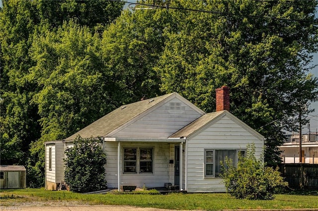 2405 Ellington St, Greensboro, NC 27403 - bungalow featuring a chimney and a storage unit
