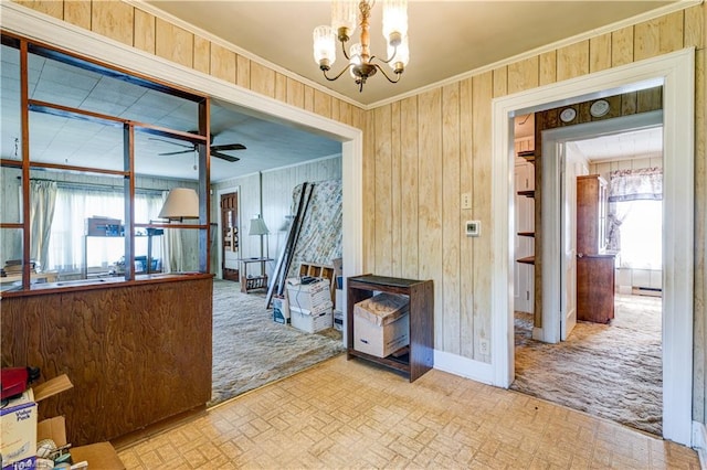 2405 Ellington St, Greensboro, NC 27403 - dining space featuring ornamental molding, a chandelier, ceiling fan, wooden walls, and brick patterned flooring