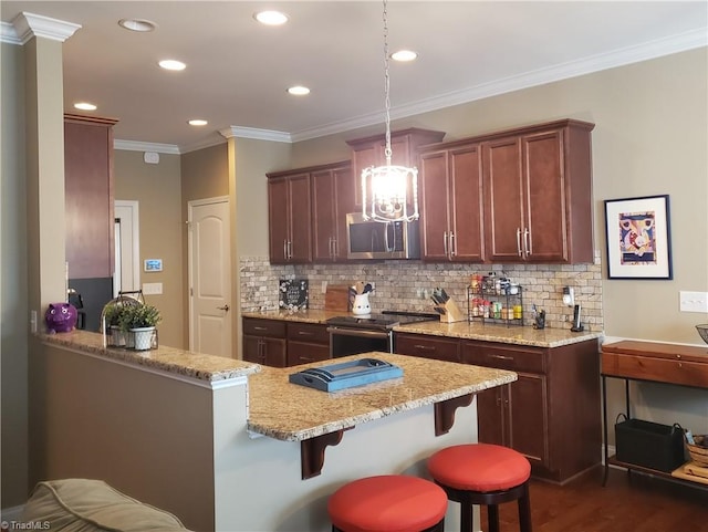 kitchen with appliances with stainless steel finishes, ornamental molding, a kitchen breakfast bar, and light stone countertops