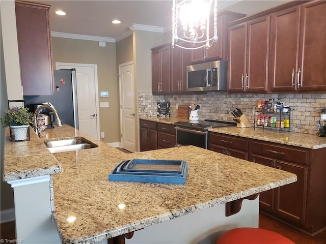 kitchen featuring stainless steel appliances, light stone counters, a sink, and decorative backsplash