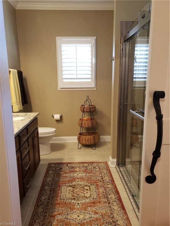 bathroom featuring ornamental molding, plenty of natural light, a shower stall, and vanity