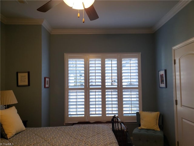 bedroom with a ceiling fan and crown molding