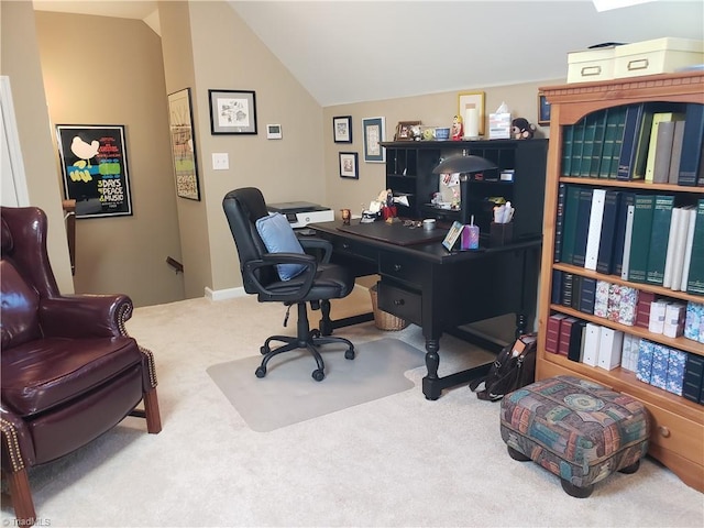 carpeted home office with vaulted ceiling