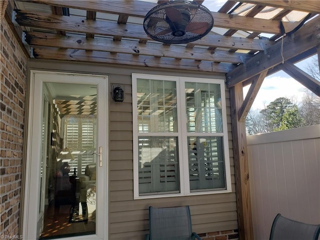 exterior space with brick siding and a pergola