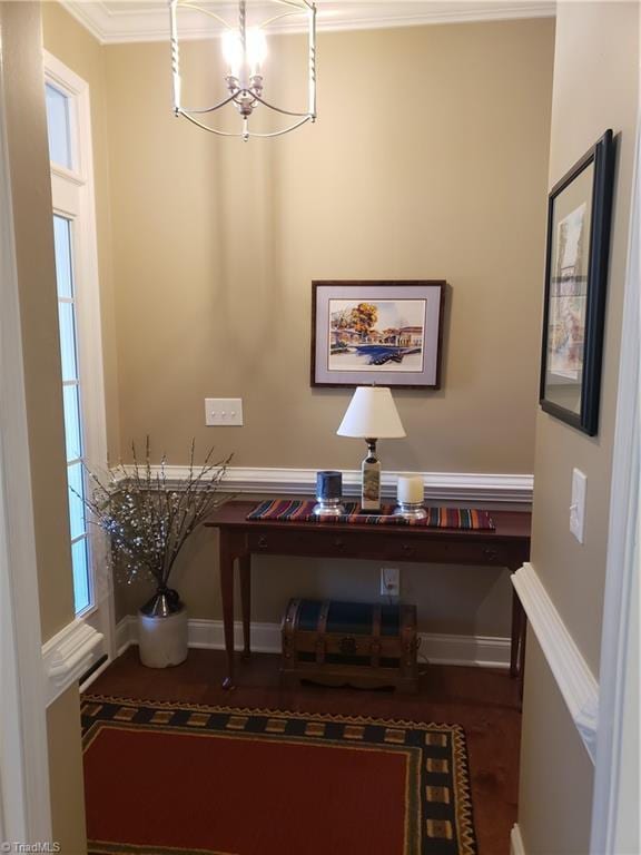 home office with crown molding and a chandelier