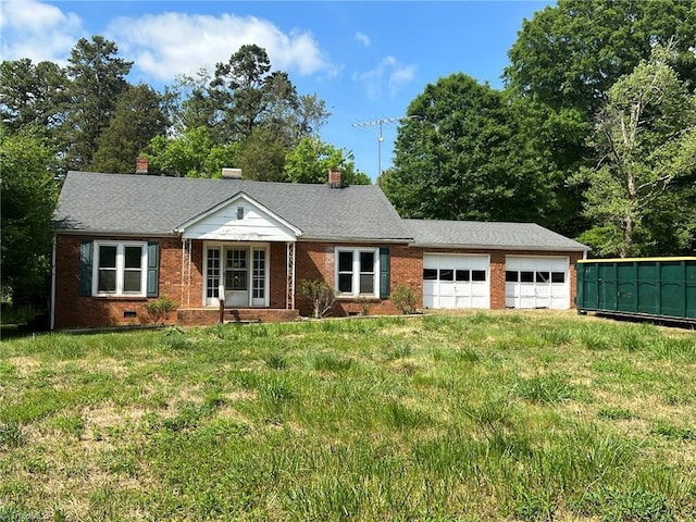 single story home featuring a garage, a front yard, and brick siding