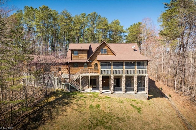 1310 Lynchburg Rd, Westfield, NC 27053 - rear view of house featuring stairway, a yard, a sunroom, stone siding, and a patio