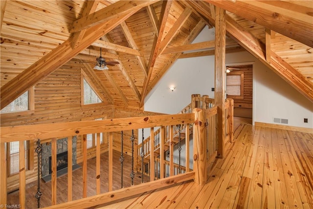1310 Lynchburg Rd, Westfield, NC 27053 - interior space with visible vents, an upstairs landing, light wood-style floors, and vaulted ceiling with beams