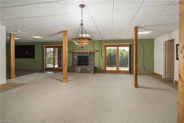 1310 Lynchburg Rd, Westfield, NC 27053 - unfurnished living room featuring a drop ceiling, baseboards, a fireplace, and carpet flooring