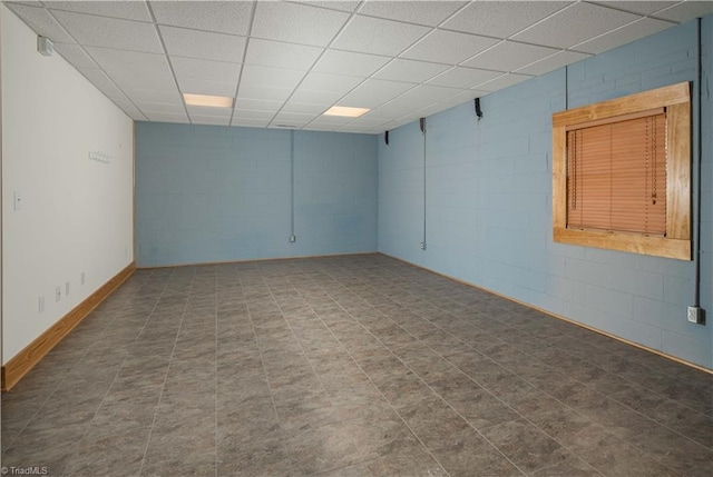 1310 Lynchburg Rd, Westfield, NC 27053 - spare room with baseboards, concrete block wall, and a paneled ceiling