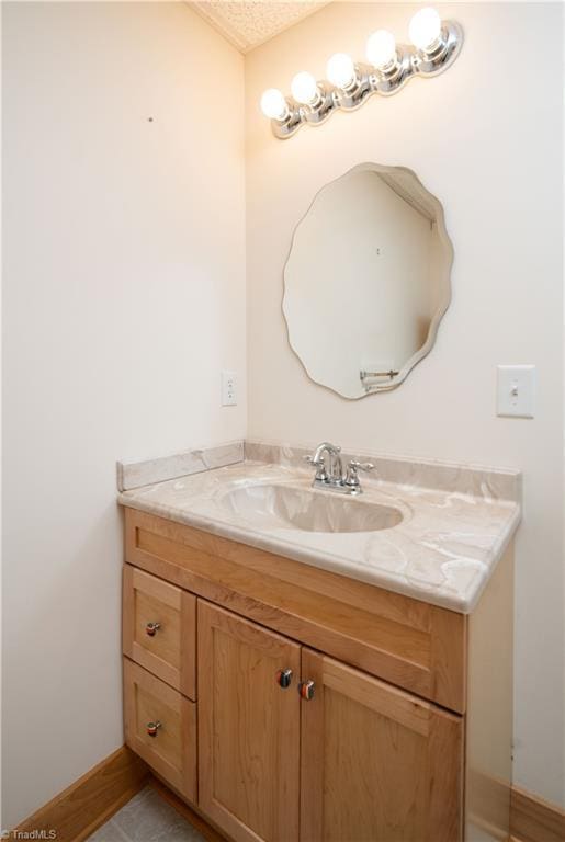 1310 Lynchburg Rd, Westfield, NC 27053 - bathroom featuring a textured ceiling, vanity, and baseboards