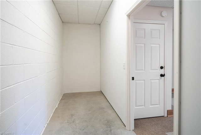 1310 Lynchburg Rd, Westfield, NC 27053 - hall with concrete block wall, a paneled ceiling, and concrete flooring