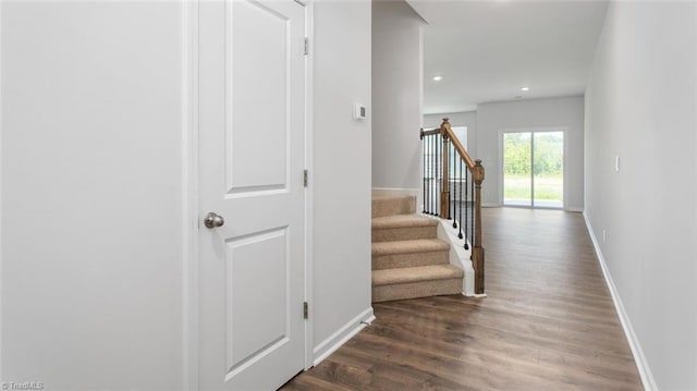 corridor featuring recessed lighting, stairs, baseboards, and wood finished floors