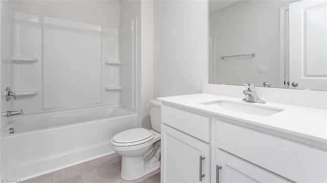 bathroom featuring washtub / shower combination, toilet, and vanity