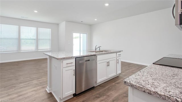 kitchen featuring stainless steel dishwasher, wood finished floors, white cabinetry, and a sink