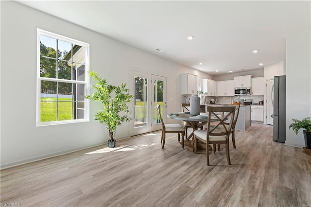 dining space with light wood-style flooring, recessed lighting, and visible vents