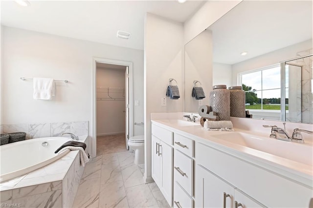 bathroom with a sink, marble finish floor, a stall shower, and double vanity