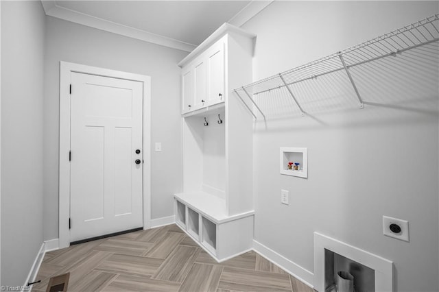 laundry room featuring hookup for an electric dryer, crown molding, cabinet space, baseboards, and hookup for a washing machine