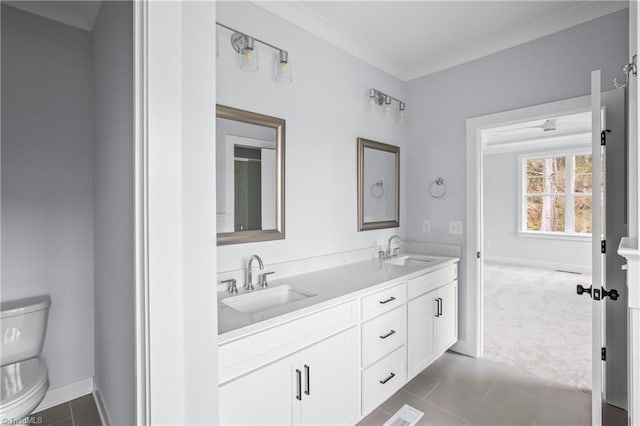 full bathroom featuring a sink, tile patterned flooring, toilet, and double vanity