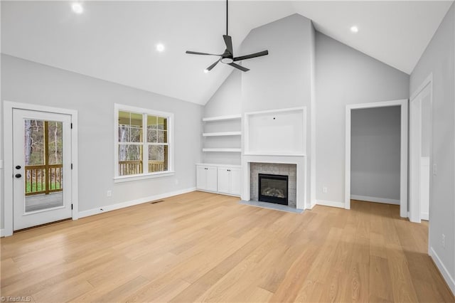 unfurnished living room featuring light wood-style floors, high vaulted ceiling, ceiling fan, and baseboards