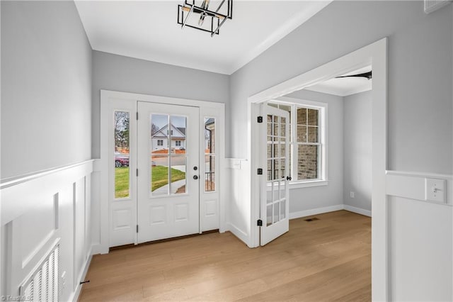 entrance foyer featuring visible vents, a wealth of natural light, and light wood-style flooring