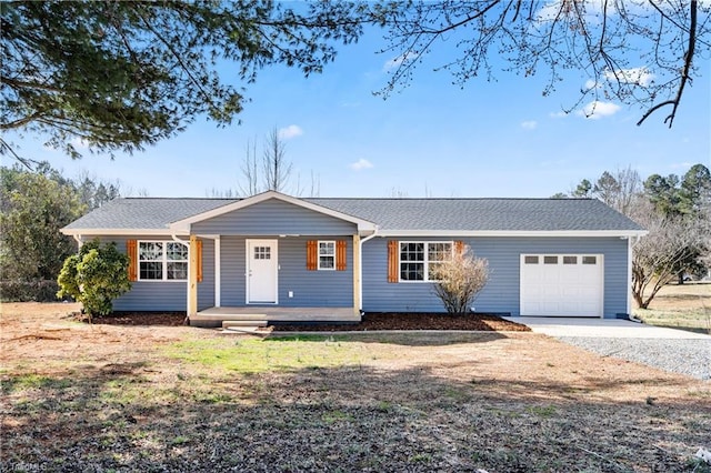 ranch-style home with a garage, a porch, and driveway