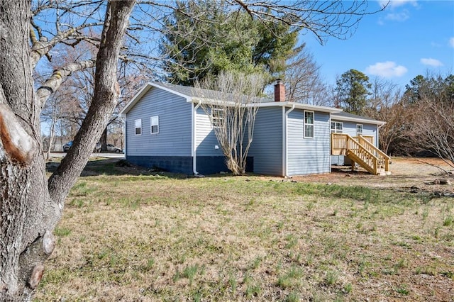 back of property with a yard and a chimney