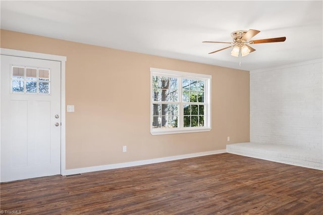 spare room with a ceiling fan, wood finished floors, and baseboards