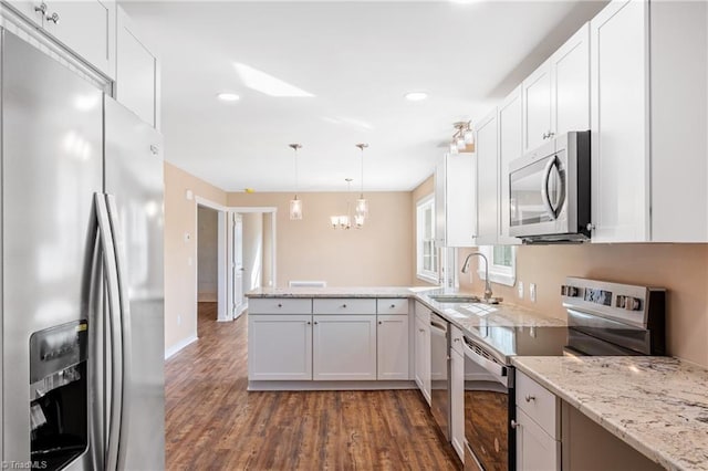 kitchen with white cabinetry, stainless steel appliances, and a sink