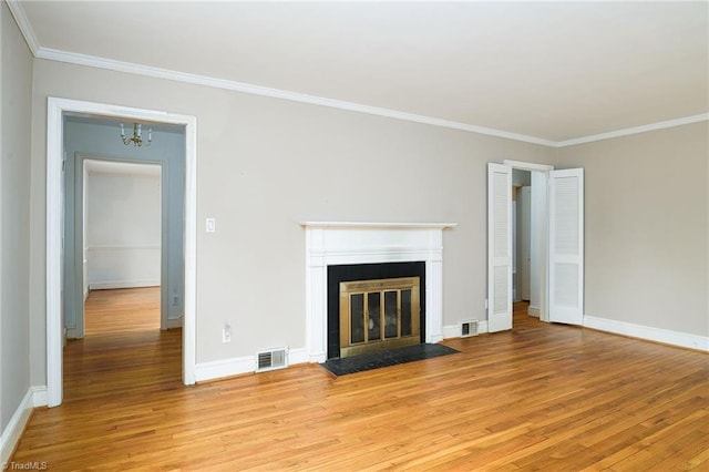 515 N Pine Valley Rd N, Winston-Salem, NC 27106 - unfurnished living room featuring a fireplace with flush hearth, light wood-type flooring, crown molding, and a chandelier