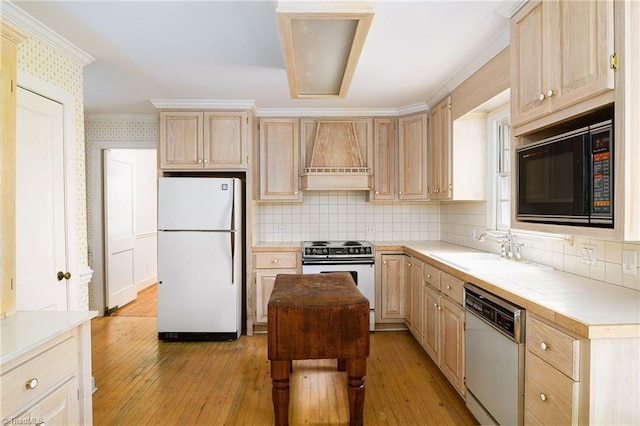 515 N Pine Valley Rd N, Winston-Salem, NC 27106 - kitchen with white appliances, light brown cabinetry, custom exhaust hood, light wood finished floors, and backsplash