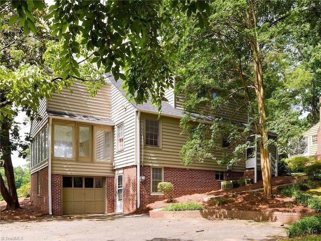 515 N Pine Valley Rd N, Winston-Salem, NC 27106 - view of front of home with a garage, brick siding, roof with shingles, and asphalt driveway