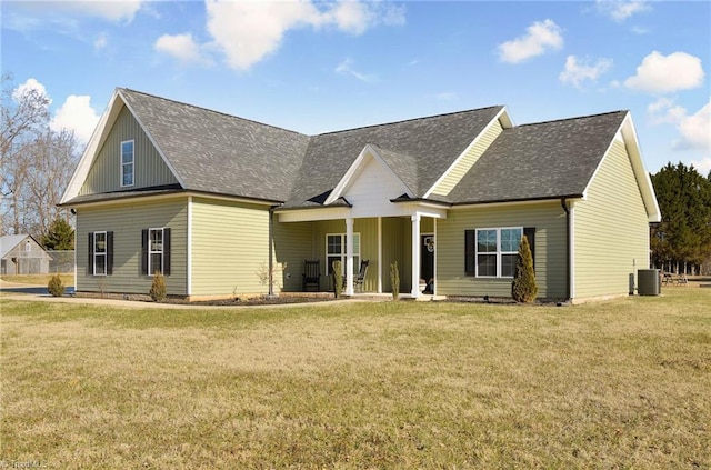 rear view of property with a yard and central air condition unit