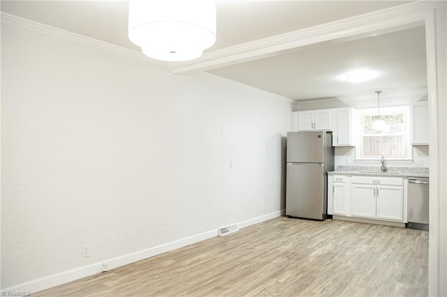 kitchen featuring stainless steel appliances, crown molding, pendant lighting, white cabinets, and light hardwood / wood-style floors