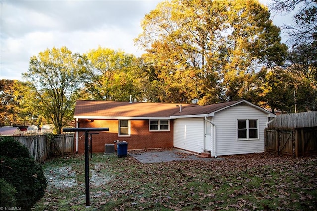 back of property featuring a patio and central AC